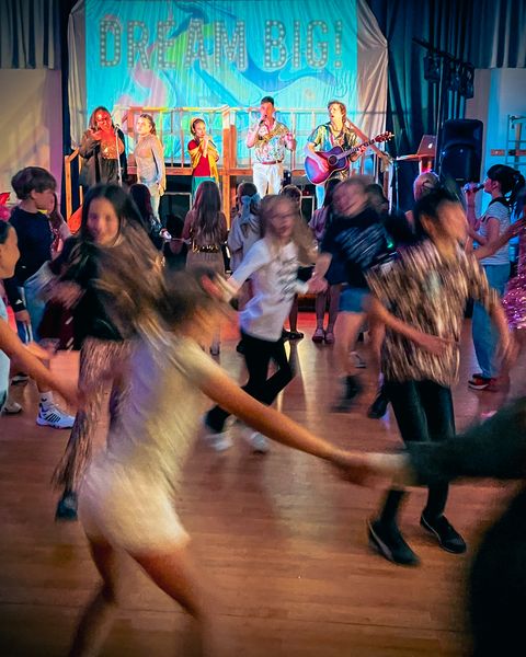 Children dancing in front of the stage