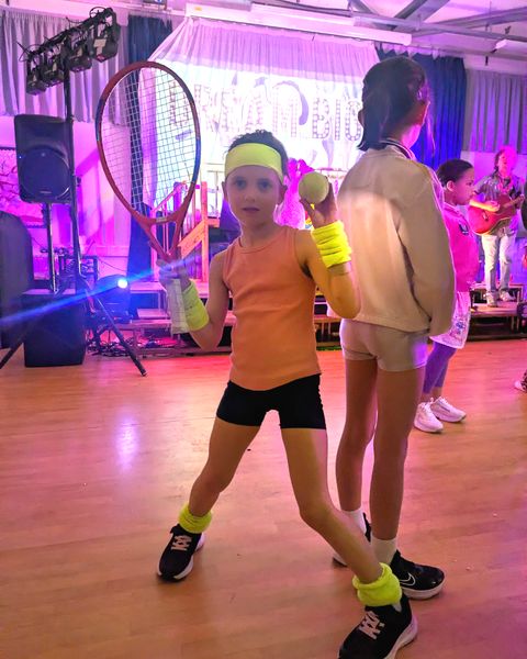 A child dressed as a tennis champion at a live show