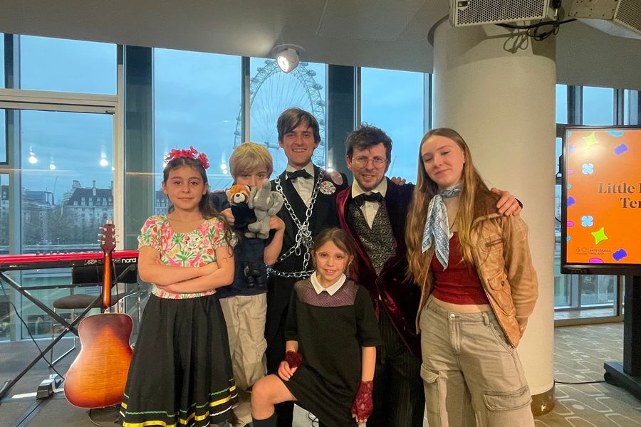 Performers and young singers in front of the London Eye at the Southbank Centre