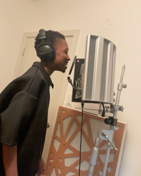 Michael Yakubu smiling in the vocal booth